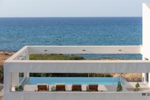 a view of the ocean from a house at Zen Luxury Villas & Suites, By ThinkVilla in Hersonissos