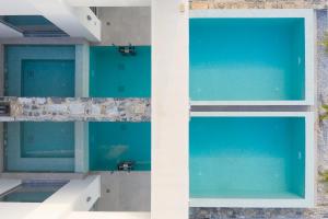 two views of a pool in a building at Zen Luxury Villas & Suites, By ThinkVilla in Hersonissos