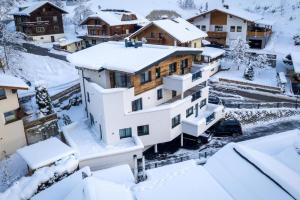 a house covered in snow in a village at Haus Sabrina Hexenkopf in See