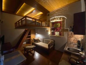 een woonkamer met een trap en een bank bij Microcosmos Halepas in Chania