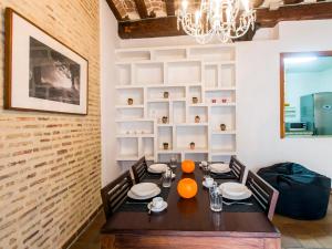 a dining room with a table and chairs and a chandelier at Total Valencia Charming in Valencia