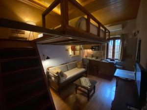 sala de estar con cama elevada y sofá en Microcosmos Halepas, en La Canea