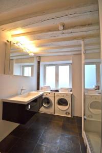 a bathroom with a sink and washing machines in it at Bahia in Paris