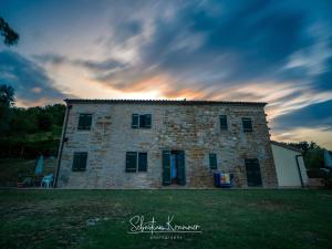 a large brick building with a sunset in the background at Casa Brizzi in San Pietro