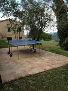 a blue ping pong table sitting on a brick patio at Casa Brizzi in San Pietro