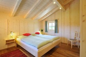 a bedroom with a large bed in a room at Lamplhof in Rimsting