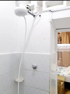 a bathroom with a shower with a light on the wall at Neighbourly Nest in Mombasa