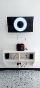 a white shelf with a tv on a wall at Neighbourly Nest in Mombasa