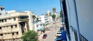 a view from a window of a city street with cars at Neighbourly Nest in Mombasa