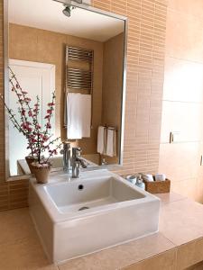 een badkamer met een grote witte wastafel en een spiegel bij Casa Branca in Tavira
