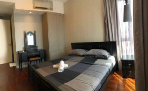 a teddy bear sitting on a bed in a bedroom at The Shore Walking To Jonker Streets 5 in Melaka
