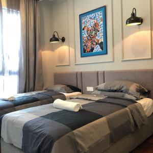 two beds sitting next to each other in a room at The Shore Walking To Jonker Streets 5 in Melaka