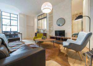 a living room with a couch and a table at Bulle in Paris