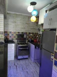 a kitchen with a stove and a refrigerator at شقةعلى البحرمباشرةسيدي بشرالمربع الذهبي in Alexandria