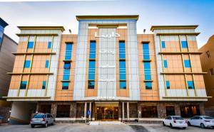 un edificio con auto parcheggiate di fronte di Darina Serviced Apartments a Riyad