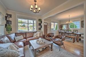 a living room with a leather couch and a table at Sunny Seattle Home with Deck about 6 Mi to Downtown in Seattle