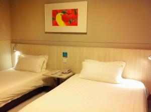 A bed or beds in a room at Jinjiang Inn - Changsha Wuyi Square