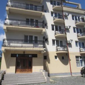 an apartment building with stairs and balconies at Casa Mario in Eforie Nord
