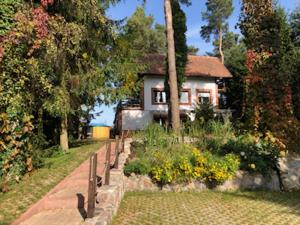 a house with a garden in front of it at Dom Pod Sosnami in Mielno