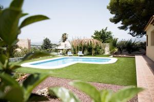 a swimming pool in a yard with grass at Family villa in Alicante, saltwater pool, AC and bbq in Alicante
