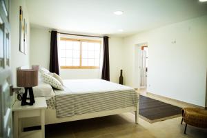 a bedroom with a bed and a window at Family villa in Alicante, saltwater pool, AC and bbq in Alicante +11 photos