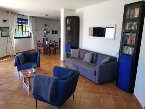 a living room with a couch and chairs and a table at Casa Luz in Hermigua