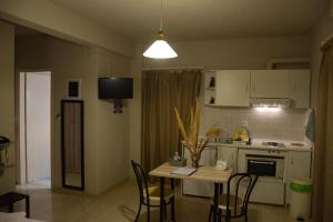 A kitchen or kitchenette at Thalis Rooms