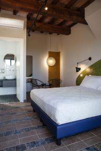 a bedroom with a bed and a table and chairs at Il Poggio di Musignano in Musignano