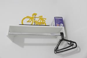 a shelf with a yellow bike on top of it at Rota 013 - Santos Canal 4 in Santos
