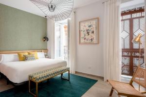 a bedroom with a bed and a green wall at Hernando Colón Olehousing in Seville +53 photos