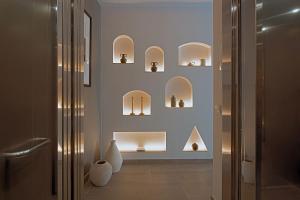 a room with shelves with vases on the wall at Hernando Colón Olehousing in Seville