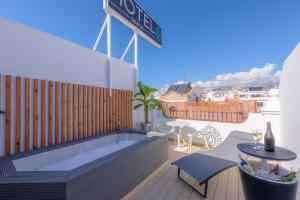 a balcony with a hot tub on top of a building at Hotel Boutique Sibarys - Adults Recommended in Nerja