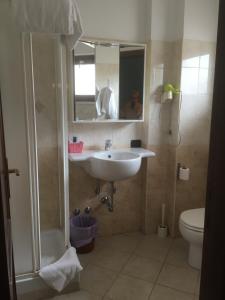 a bathroom with a sink and a toilet and a mirror at Hotel Ristorante Villa Pegaso in San Pietro Infine