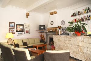 a living room with a couch and a fireplace at Hostal La Florida in Llança