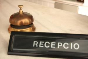 a close up of a sign on top of a counter at Hostal La Florida in Llança