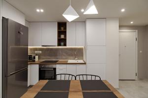 A kitchen or kitchenette at Blu & Marrone Suites-parking included