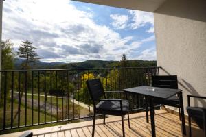 a balcony with a table and chairs and a view at Omega Apartments in Vrnjačka Banja