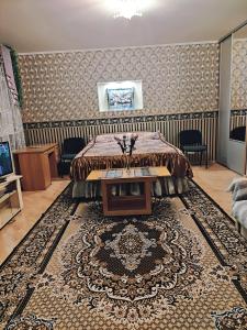 a bedroom with a bed and a table in a room at Oasis Apartments in Pärnu