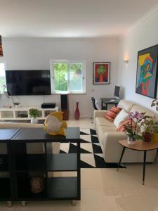 a living room with a couch and a table at Casa Branca Turismo Rural in Tavira