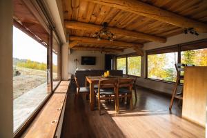 a dining room with a table and a couch at Hygge House in Vyshka
