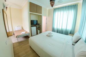 a bedroom with a large white bed and a chair at Red Sea Dive Center in Aqaba