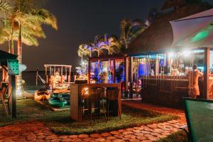 a resort with a bar and a playground at night at Blue Bird in Bacalar +32 photos