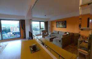 a living room with a couch and a table at Diva Capitol Luxury in Skopje