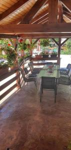 a patio with a table and chairs in a building at Casa Mimi in Băile Herculane