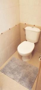 a bathroom with a white toilet and a blue rug at Na planina in Razlog +38 photos