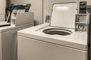 a white washer and dryer in a room at Marina Tower by TS in Honolulu