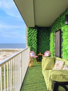 a living room with a couch on a balcony with the beach at My Beach Retreat by Nick in Gulf Shores