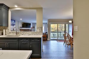 a kitchen and dining room with a view of a living room at Kettle Brook A in Ludlow