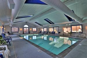 a large swimming pool in a building with tables and chairs at Winter Escape in Ludlow