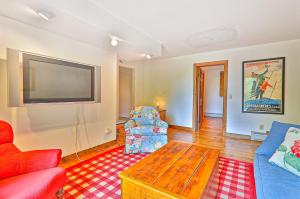 a living room with a tv and a couch and a chair at 1477 Salt Ash Road in Plymouth